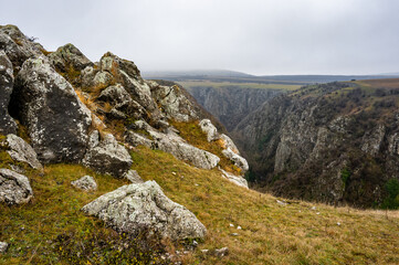 Scenic landscape of the turenii gorges (cheile turenii) in cluj county, romania, showcasing dramatic rock formations and a deep canyon on a cloudy day