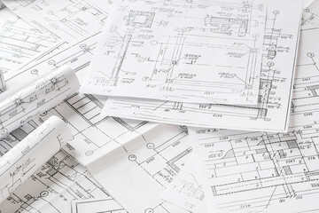Close-up architect  designer working construction blueprints planning building project.detailed drawings planning tools desk modern workspace.professional project design architecture