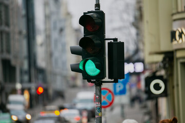 Green traffic light close up in city traffic