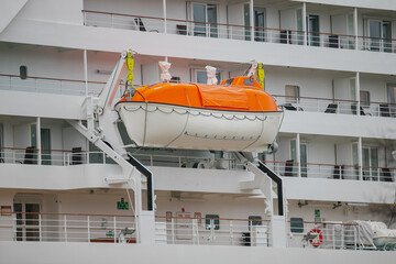 Modern cruise ships lifeboat with orange safety color roof