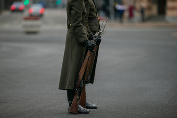Couple of latvian guards with rifles and bayonets standing in guard in Riga, Latvia