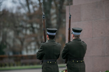 Couple of latvian guards with rifles and bayonets standing in guard in Riga, Latvia