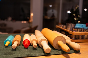 set of kneading rollers all in line, in the background christmas decoration, workshop preparation for gingerbread biscuits