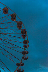 Ferris Wheel Illuminated at Night in Front of Erfurt Cathedral with Warm Lights and Dark Evening...