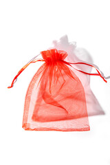 Red organza pouch on white background. Vertical. Gift bag