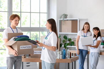 Young volunteers with donations for poor people in center