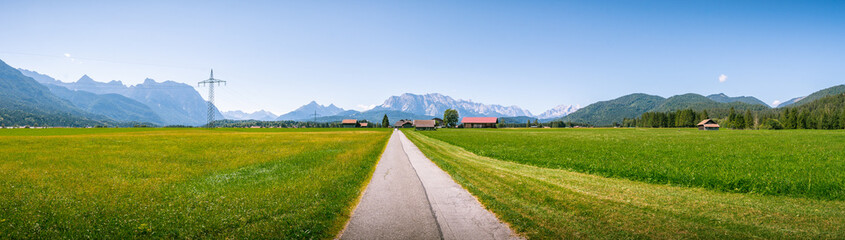 Schöne Berg Straße in Deutschland Alpen. Panorama Sicht auf Feld, Gebirge und Wiese. Idylle wandern durch Wald und Natur. 