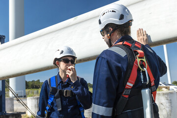 Inspection engineers a rotor blade of a wind turbine. Professional Man Maintenance engineers...