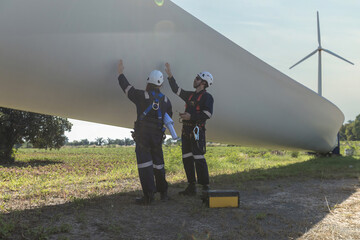 Inspection engineers a rotor blade of a wind turbine. Professional Man Maintenance engineers...