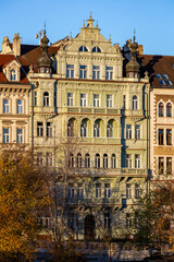 Colorful houses on the Prague waterfront, illuminated by the morning autumn sun