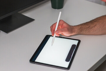 Businessman using digital tablet with stylus, work on digital tablet at home office.