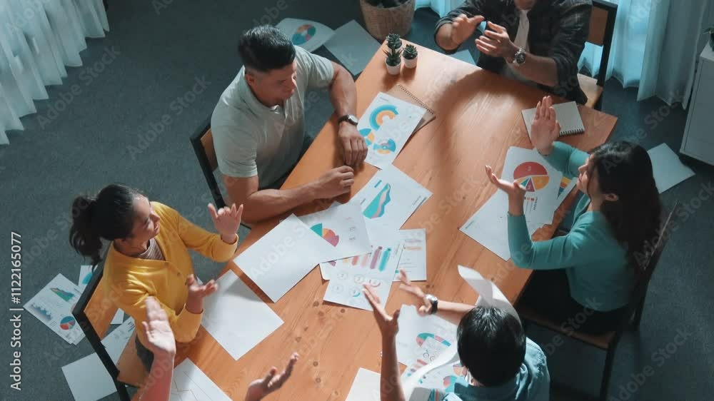 Poster top view of smart people throw paper and giving high five at meeting table with financial document a