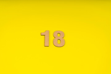 Number eighteen in leather on yellow background