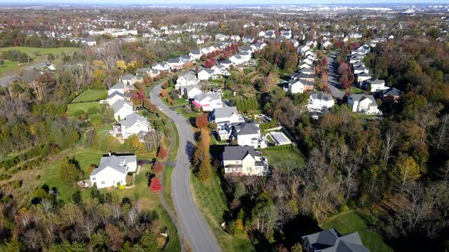 Quarters of modern upper and middle class detached houses.  Autumn landscape from a drone