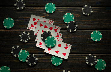 Win at poker with a lucky straight flush. Chips and cards on a black vintage table in a poker club...