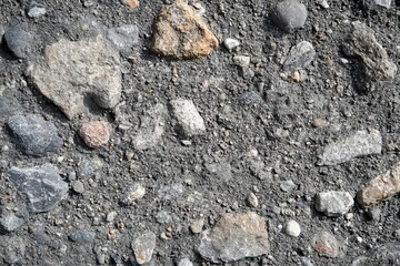 Fototapeta premium A close-up view of gravel and stones on a surface, showcasing natural textures.