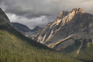 Stormy clouds over Canadian Rockies and forest valley at Yoho National Park in British Columbia,...