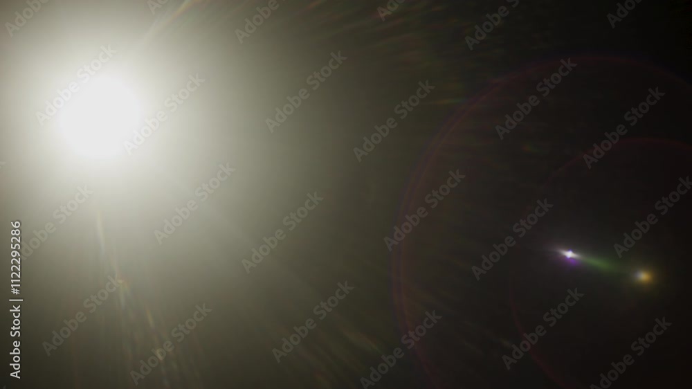 Poster Easy to add lens flare effects for overlay designs or screen blending mode to make high-quality images. Abstract sun burst, digital flare, iridescent glare over black background.