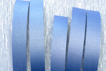 curled blue paper stripes arranged on silvery crepe paper