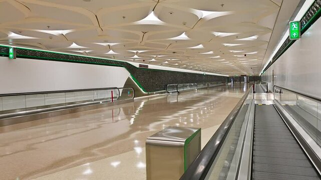 The moment when trains pass through the moving walkway at the metro station in Doha, Qatar