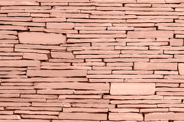 Fototapeta premium Light brown grunge stone wall masonry, background, texture. Demonstrating color of 2025 year - Mocha Mousse