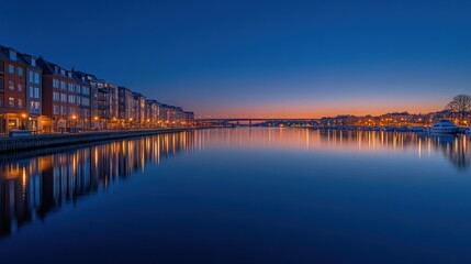 Calm twilight cityscape reflected in still water, showcasing colorful buildings and a bridge at sunset.