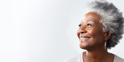 Close-up portrait of a senior old black african american woman with grey hair, isolated on white background