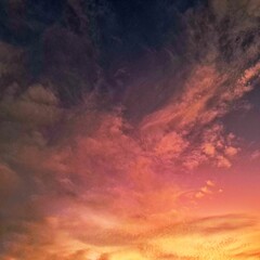 Obraz premium Summer clouds in vibrant sunset hues of yellow, orange, pink, and purple, creating a serene and colorful sky