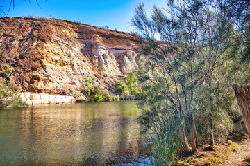 Fototapeta premium An oasis in the dry outback: the Ellendale Pool, bounded by high cliffs. Part of the Greenough River, in the Geraldton area of Western Australia 