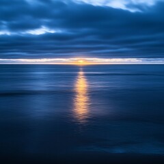 Obraz premium Serene sunset over calm ocean waters.