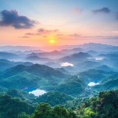 Fototapeta premium Sunrise over misty mountain range with lakes.
