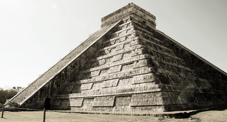 Fototapeta premium Capture the timeless beauty of Chichen Itza – an iconic UNESCO World Heritage Site showcasing the grandeur of Mayan civilization with its majestic pyramids, ancient temples, and rich cultural history.