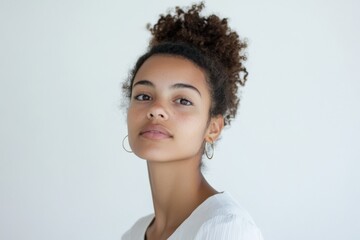 Portrait of a Young Woman with Curly Hair Against a Minimalist Background