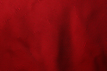 Vibrant red sports fabric showcases intricate jersey texture. 