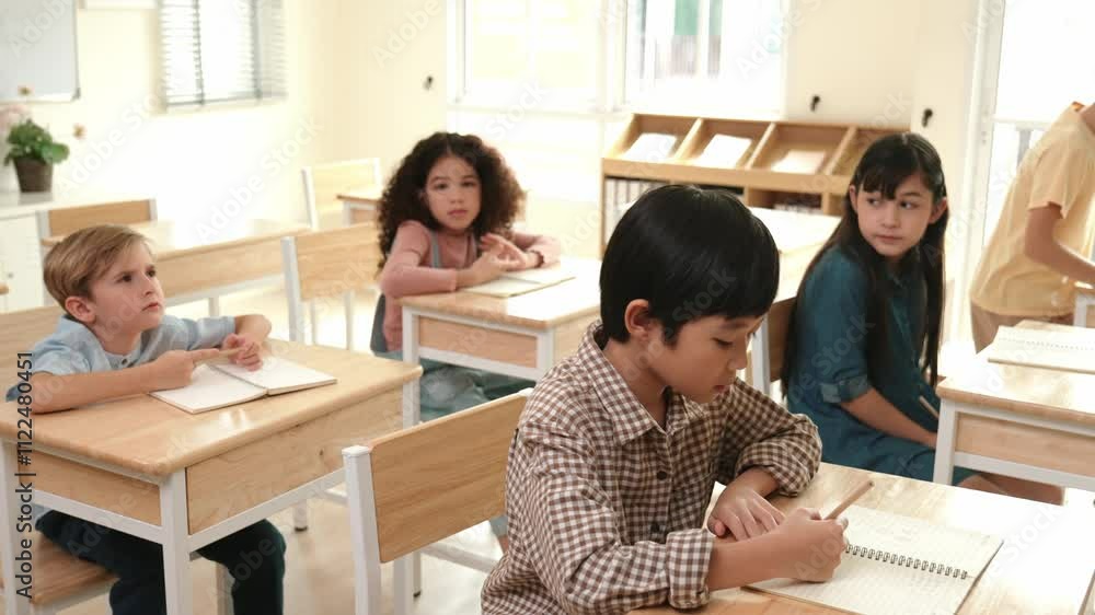 Poster asian skilled student working on classwork or doing test while sitting at classroom. diverse childre