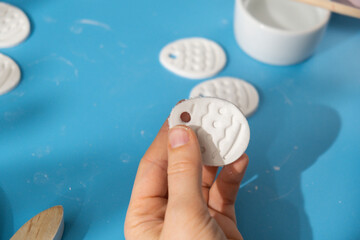 Unrecognizable artist do it yourself air dry clay crafts for Easter holiday. Decoration gift idea...