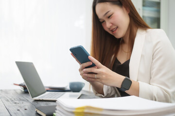 A young, professional businesswoman working at her desk in an office, providing online legal...