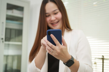 A cheerful businesswoman works at her office desk as a legal consultant, handling online civil...