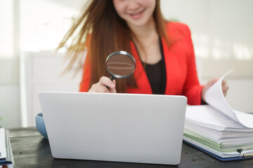 A cheerful businesswoman works at her office desk as a legal consultant, handling online civil...