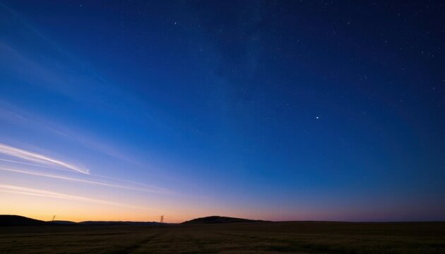 a lone tree stands in the middle of a field under a starr sky