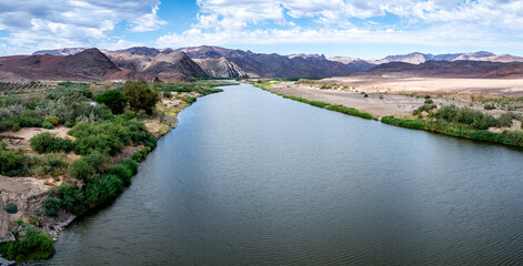 Panoramic aerial view of the Orange River, the border between South Africa and Namibia and fertile...