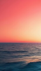 sunset over the ocean with a pink sky and a small wave