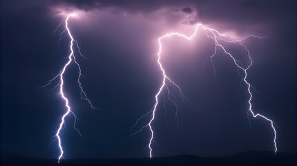Dramatic Night Sky with Two Powerful Lightning Strikes Illuminating Dark Clouds over a Silhouetted Landscape