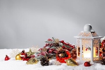 Christmas card balls and lantern on snow