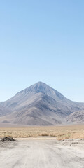Majestic mountain soaring above the arid landscape under clear blue sky