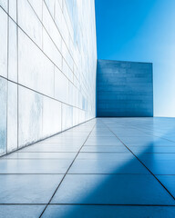 Obraz premium Modern architectural design featuring clean lines and geometric shapes under bright blue sky
