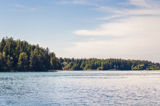 A sunny morning in a Pacific Ocean bay with mountains in the background 