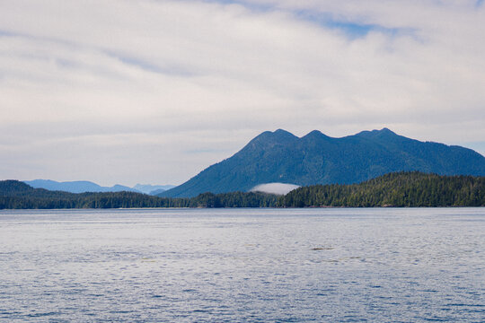 Morning in a Pacific Ocean bay with mountains in the background 