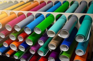 Rolls of colored self-adhesive vinyl film in different shades. Pasting with film.Auto-retailing....