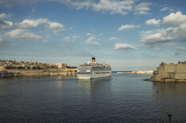 Gigantic cruiseship cruise ship liner Fascinosa sail away departure from old town Valletta, Malta...